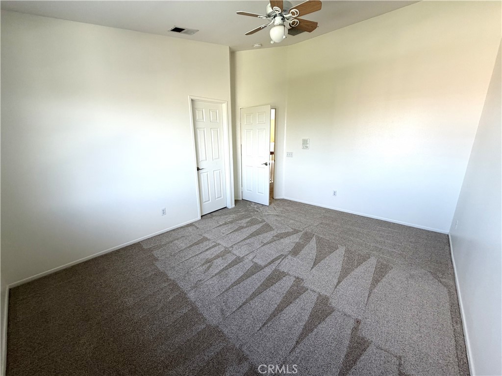 873 Greenridge Road Corona, CA 92882 - Photo 24 of 30 an empty room with a chandelier fan and windows