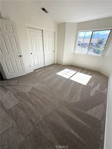 a bathroom with a granite countertop sink a toilet a mirror and vanity
