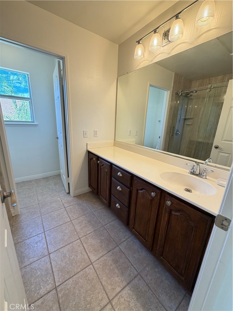 873 Greenridge Road Corona, CA 92882 - Photo 26 of 30 a bathroom with a double vanity sink and mirror