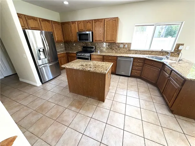 a large bathroom with a granite countertop sink a mirror and vanity