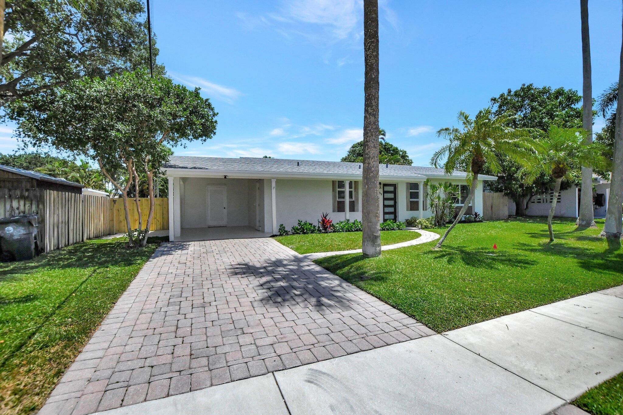 832 Southwest 10th Avenue Boca Raton, FL 33486 - Photo 2 of 57 a front view of a house with garden