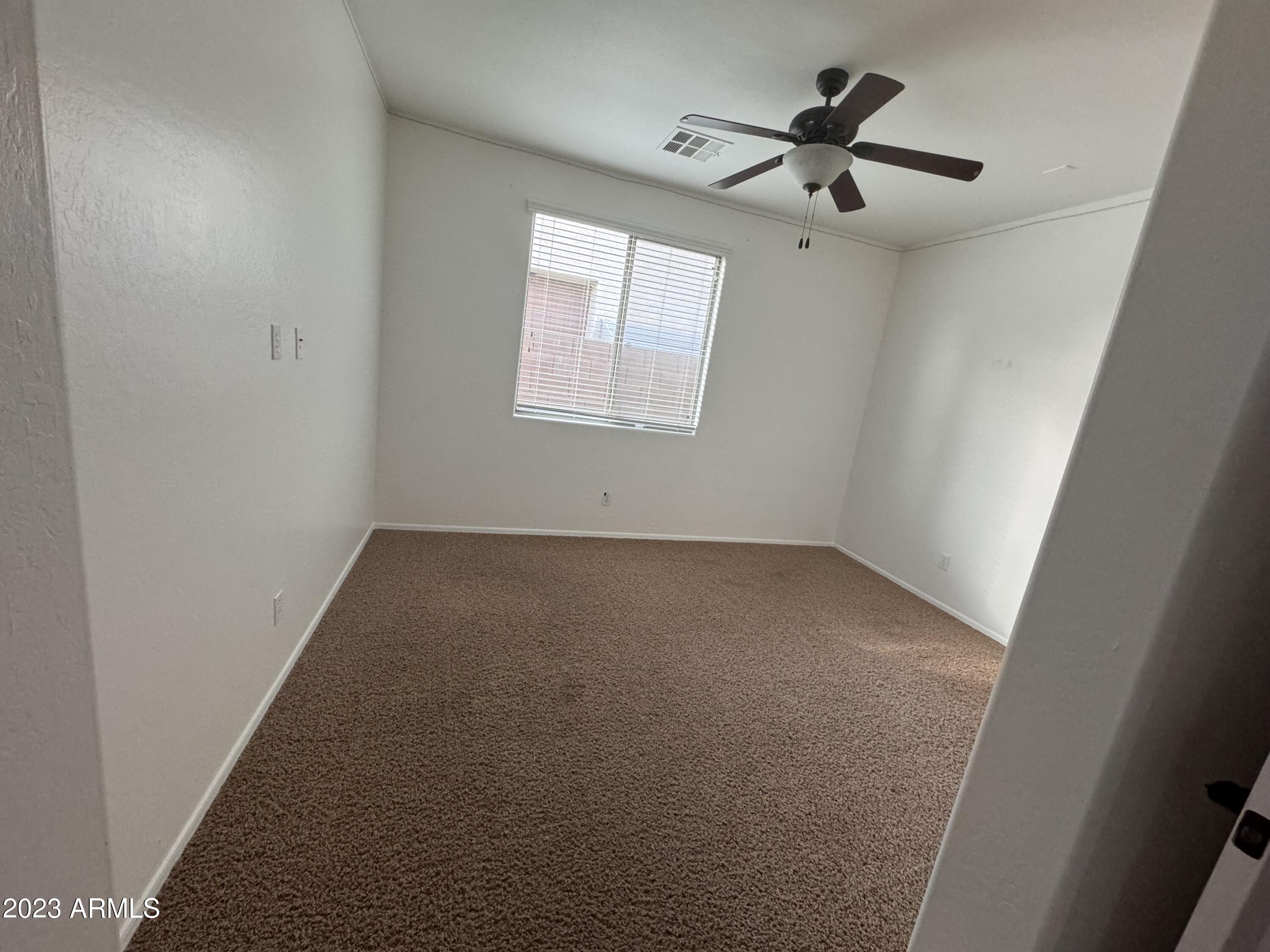3753 East Phelps Street Gilbert, AZ 85295 - Photo 12 of 18 an empty room with a window and a fan