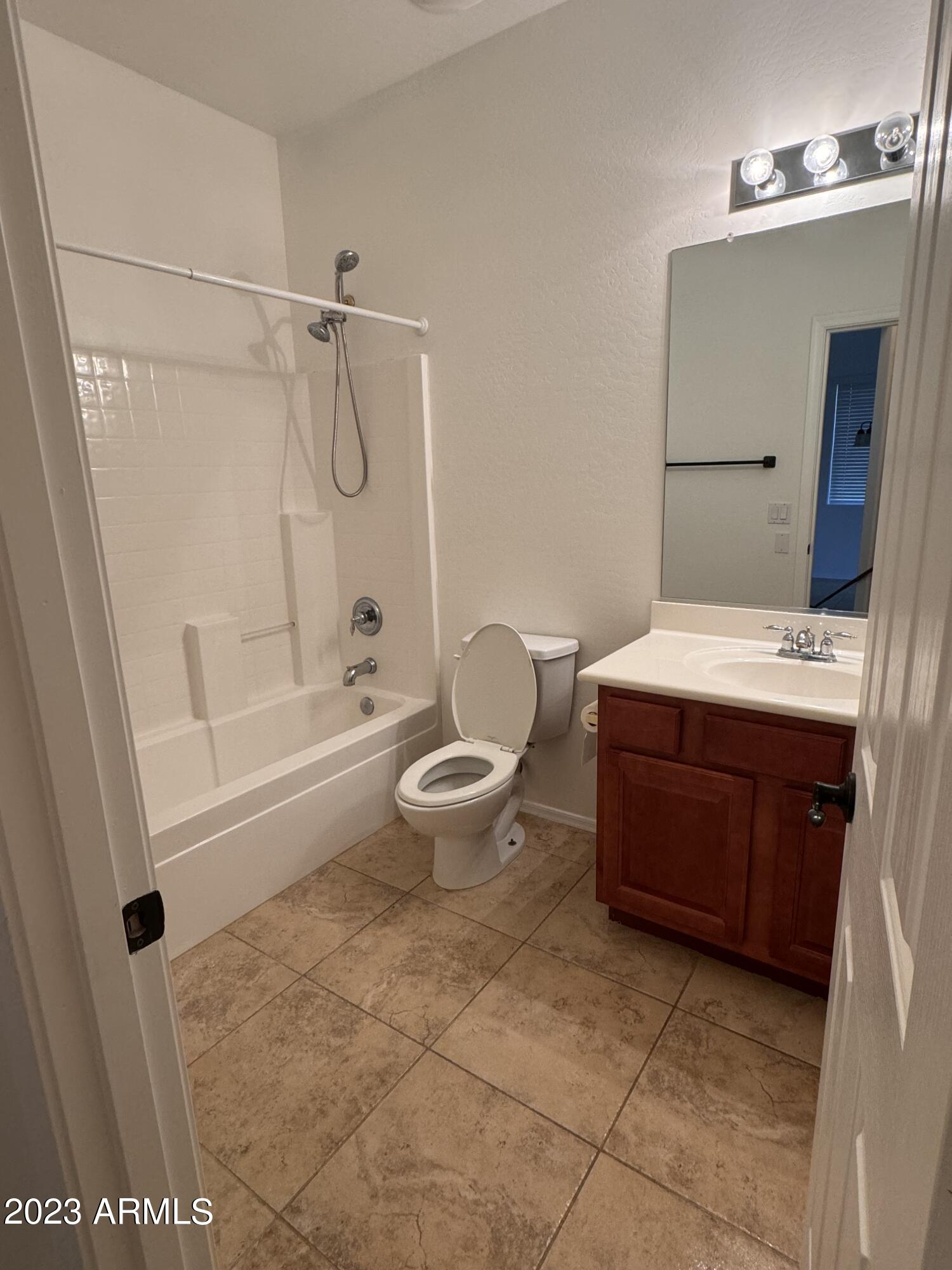 3753 East Phelps Street Gilbert, AZ 85295 - Photo 15 of 18 a bathroom with a granite countertop sink a toilet and shower