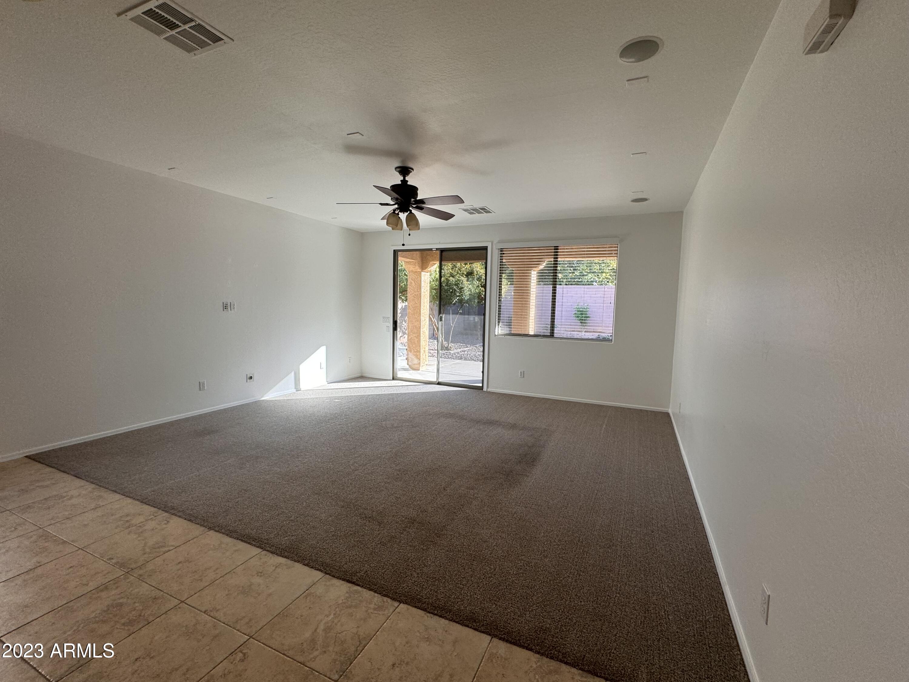 3753 East Phelps Street Gilbert, AZ 85295 - Photo 4 of 18 an empty room with windows and ceiling fan view