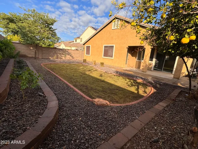 a view of a house with a backyard