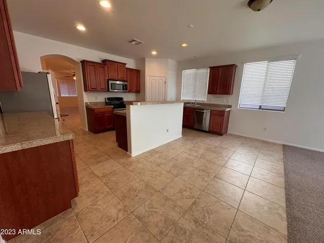 a kitchen with stainless steel appliances a refrigerator and a stove top oven