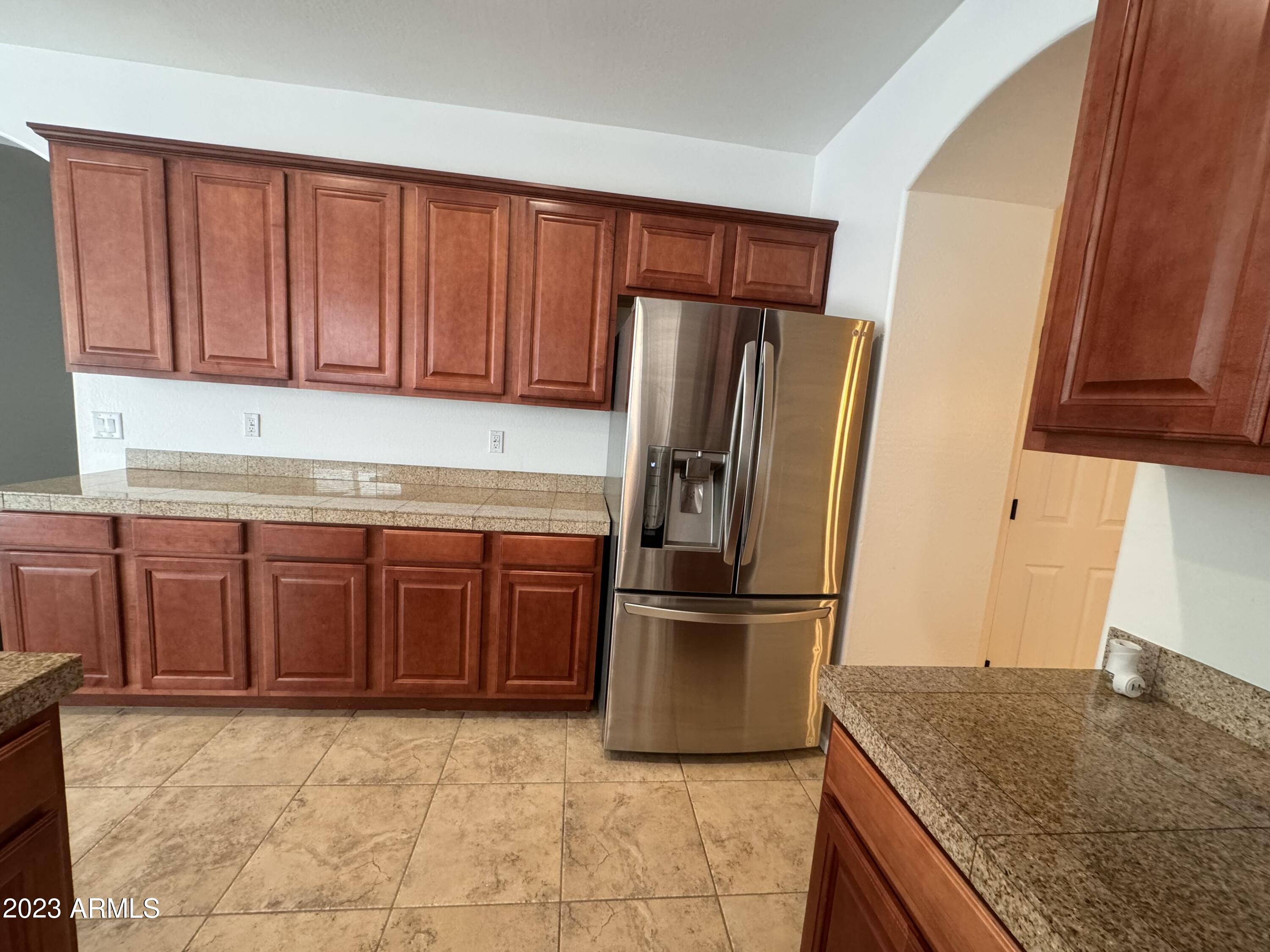 3753 East Phelps Street Gilbert, AZ 85295 - Photo 10 of 18 a kitchen with stainless steel appliances granite countertop a refrigerator and a sink