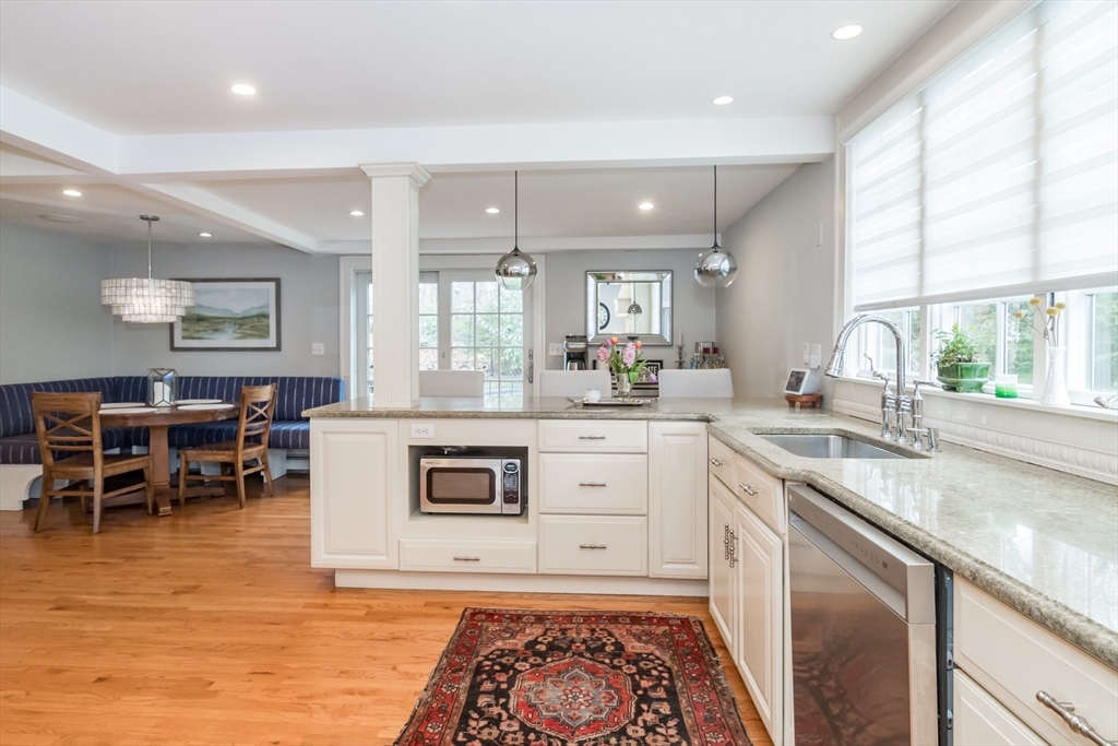 20 Colburn Road Wellesley, MA 02481 - Photo 12 of 31 a kitchen with stainless steel appliances granite countertop a sink a stove a dining table and chairs