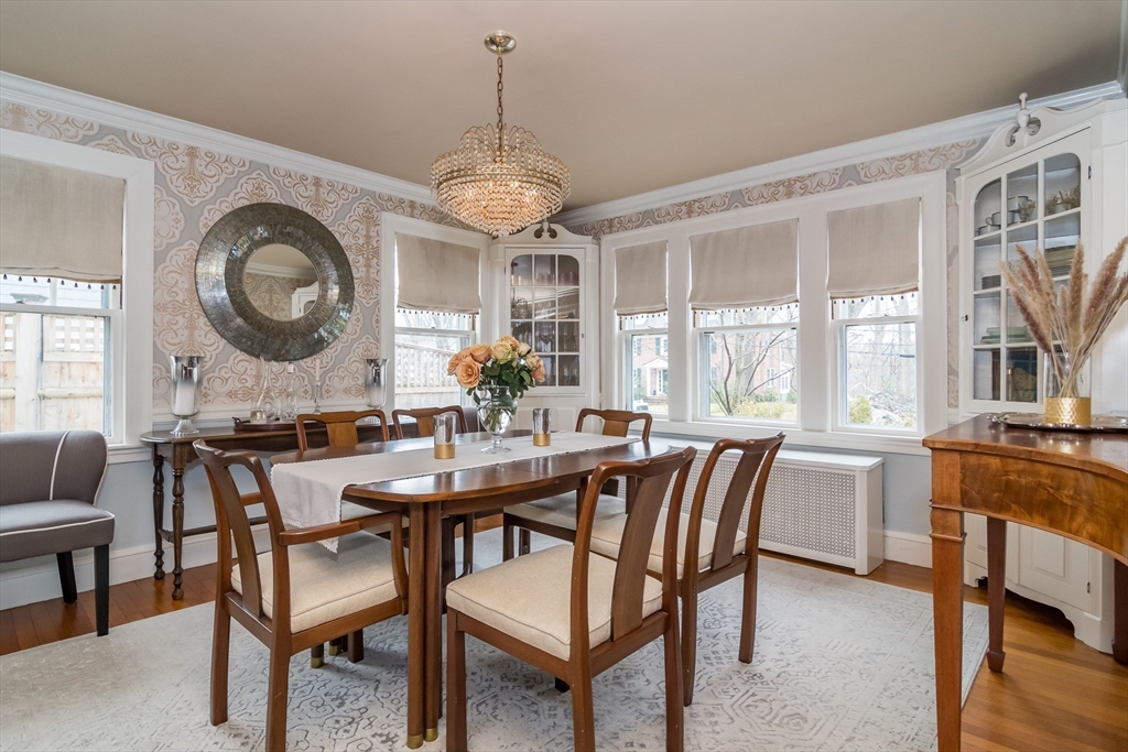 20 Colburn Road Wellesley, MA 02481 - Photo 8 of 31 a dining room with wooden floor a chandelier a wooden table and chairs