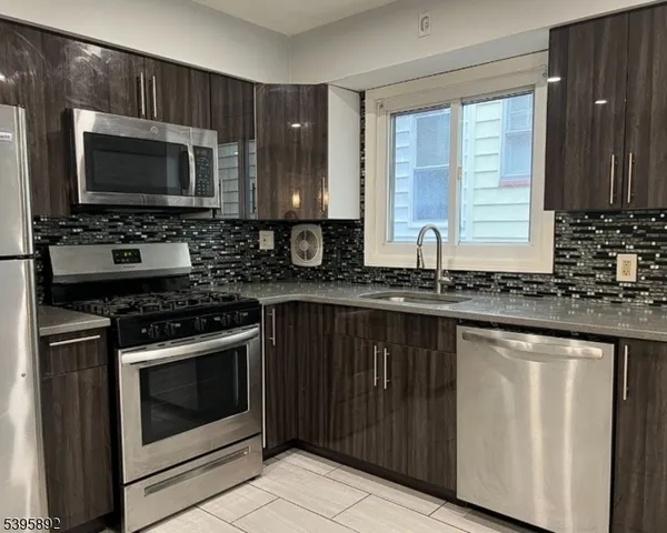 a kitchen with a stove microwave and sink