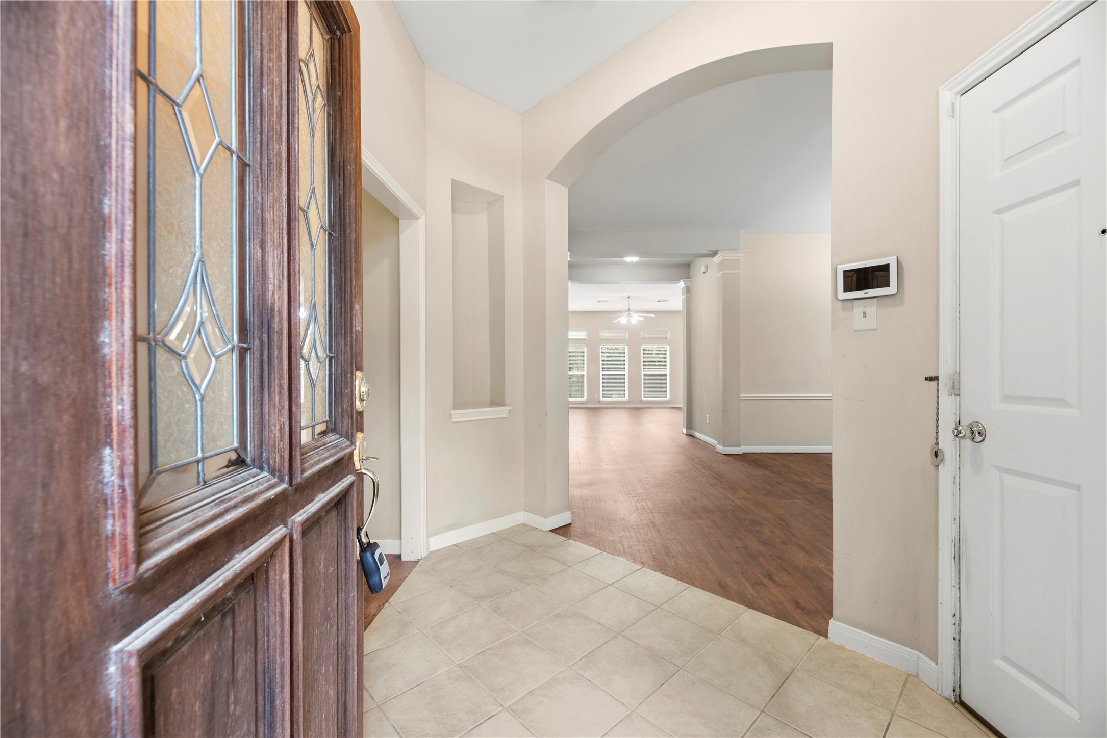 11619 Cedarvale Lane Tomball, TX 77377 - Photo 2 of 32 a view of a hallway with wooden floor and staircase