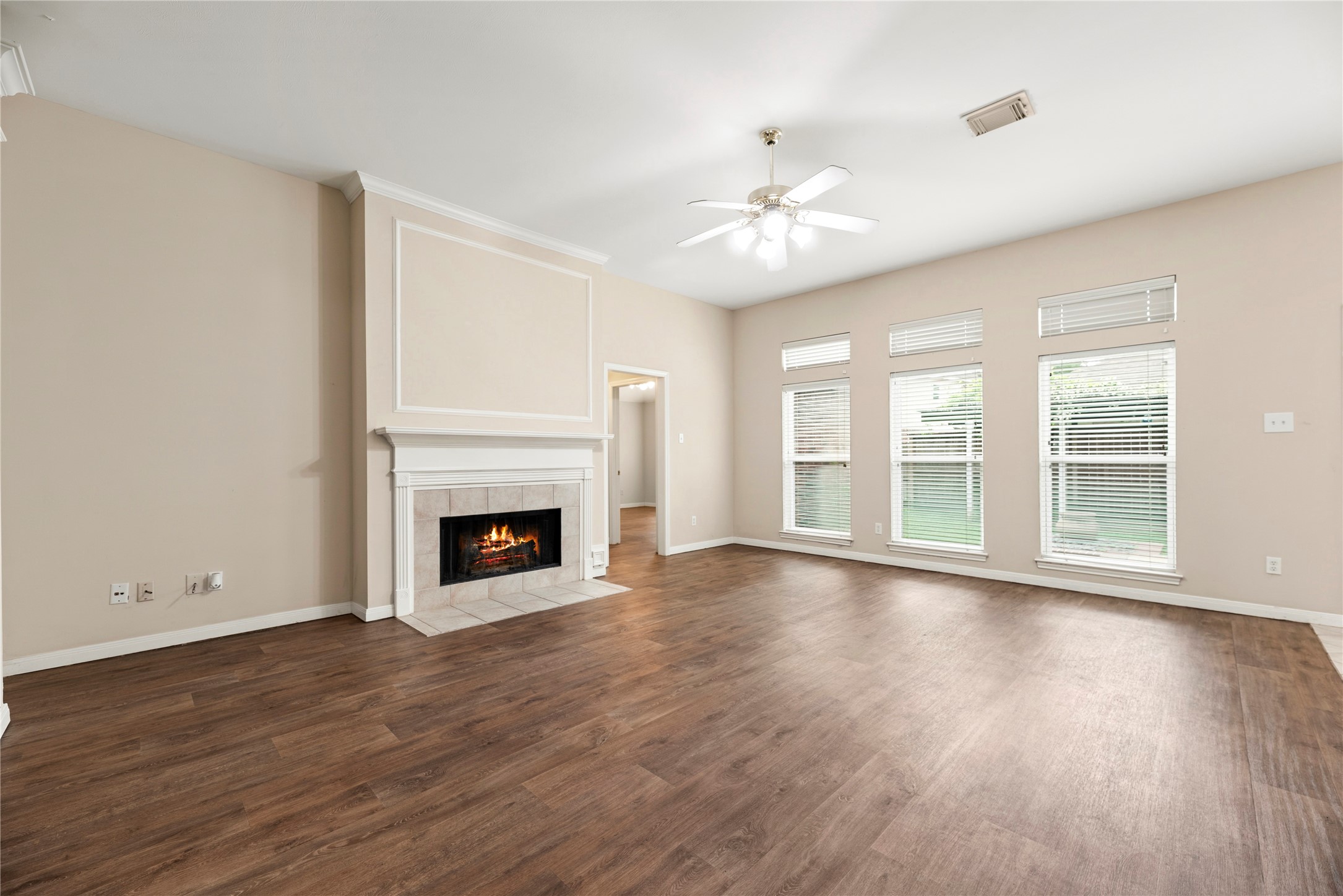 11619 Cedarvale Lane Tomball, TX 77377 - Photo 5 of 32 a view of an empty room with wooden floor fireplace and a window