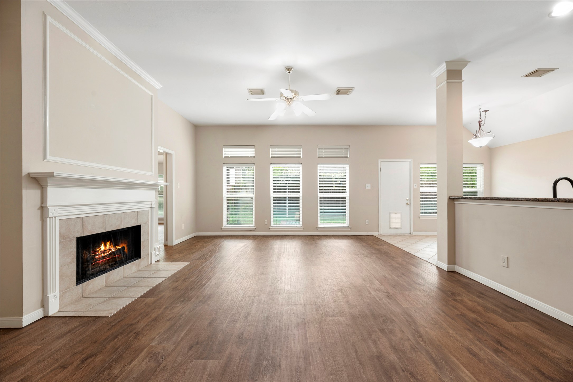 11619 Cedarvale Lane Tomball, TX 77377 - Photo 6 of 32 a view of an empty room with wooden floor fireplace and a window