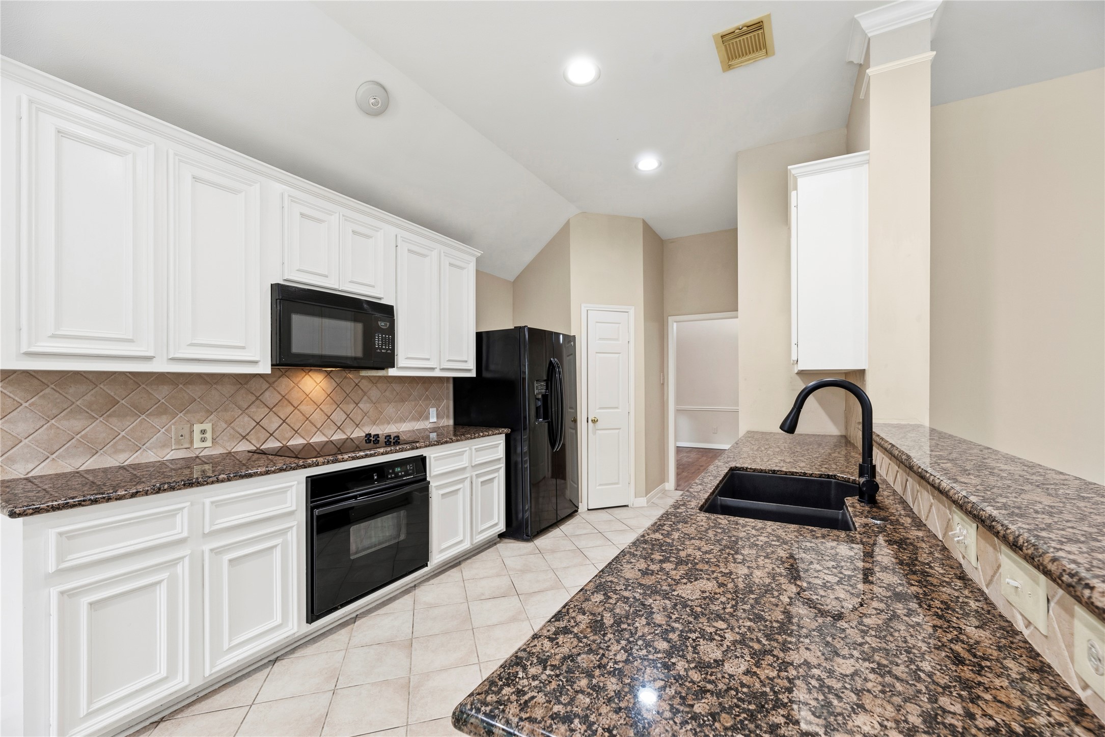 11619 Cedarvale Lane Tomball, TX 77377 - Photo 8 of 32 a kitchen with granite countertop a stove a sink and a refrigerator