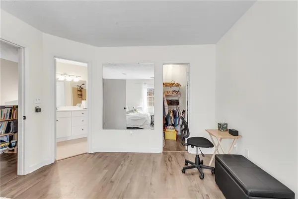a view of a workspace with furniture and wooden floor
