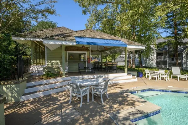 a view of a patio with a table and chairs under an umbrella