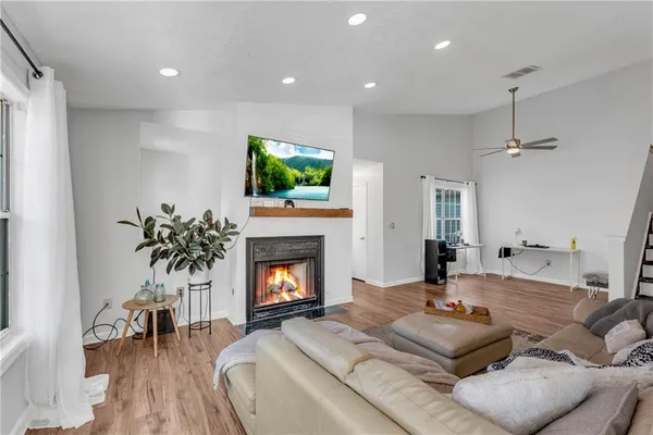 a living room with furniture a fireplace and a flat screen tv