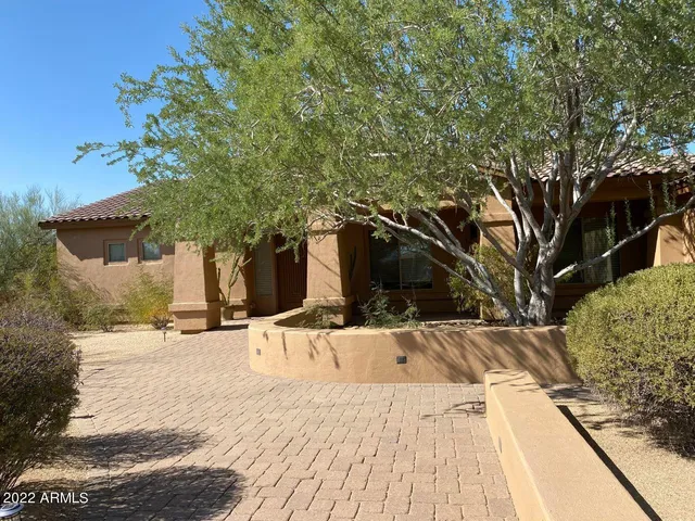 a view of a house with snow on the background