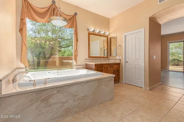 a spacious bathroom with a tub and a sink