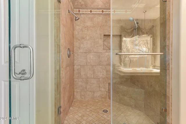 a bathroom with a glass shower door
