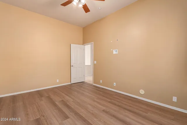 an empty room with a empty space and a ceiling fan