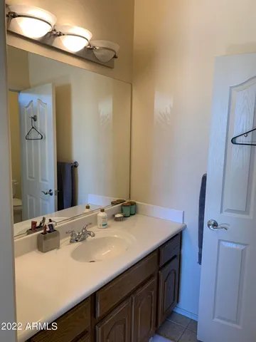 a bathroom with a sink vanity and a mirror