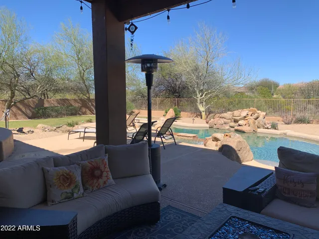 a view of swimming pool with outdoor seating and plants
