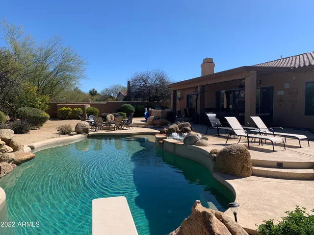 a view of a house with swimming pool and sitting area