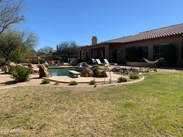 a view of a backyard with sitting area