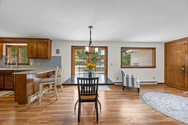 an empty room with windows and wooden floor