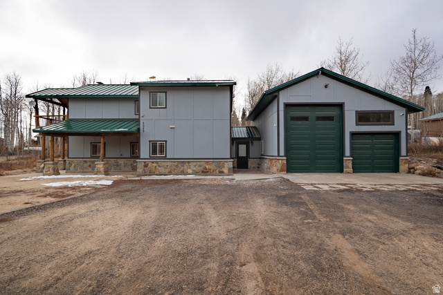 2029 West Tollgate Road Coalville, UT 84017 - Photo 1 of 36 Two-story residence with a covered porch, stone veneer foundation, and a detached two-door garage