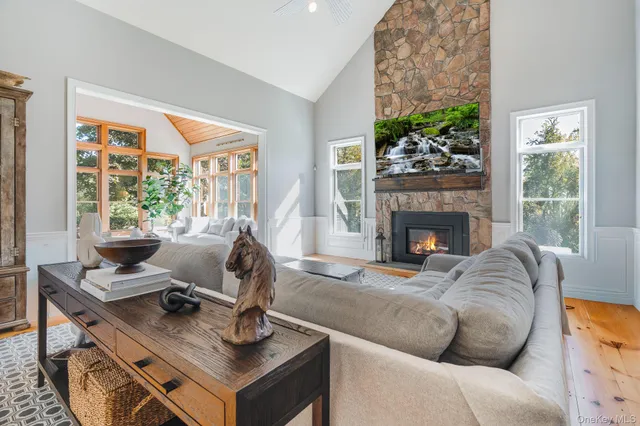 a living room with granite countertop furniture a fireplace and a chandelier