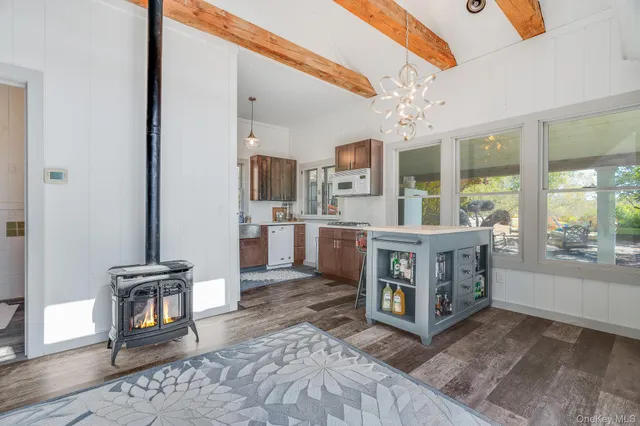 a living room with furniture a window and a dining table