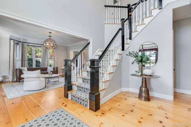 a view of hall way with furniture and floor to ceiling window