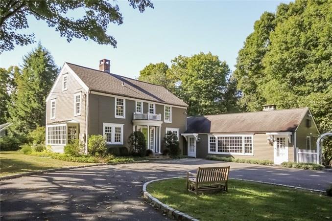 941 Ridgefield Road Wilton, CT 06897 - Photo 1 of 1 a front view of house with yard and trees around