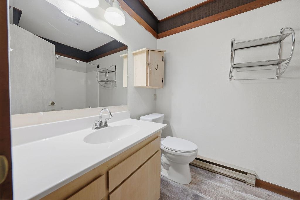 39 Graeagle Meadows Road, Unit 39 Graeagle, CA 96103 - Photo 20 of 48 a bathroom with a sink a toilet and a large mirror