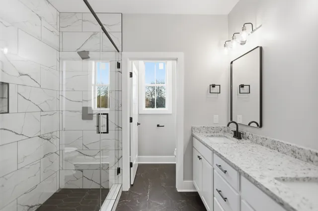 a bathroom with mirror sink and vanity