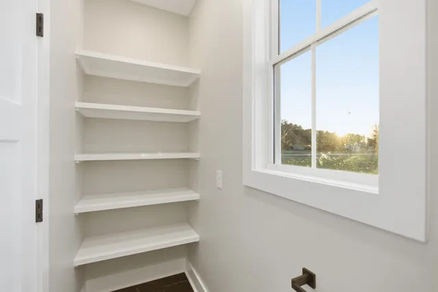 a view of walk in closet with empty racks
