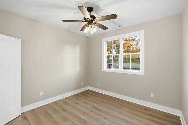 a bathroom with a granite countertop toilet sink and mirror