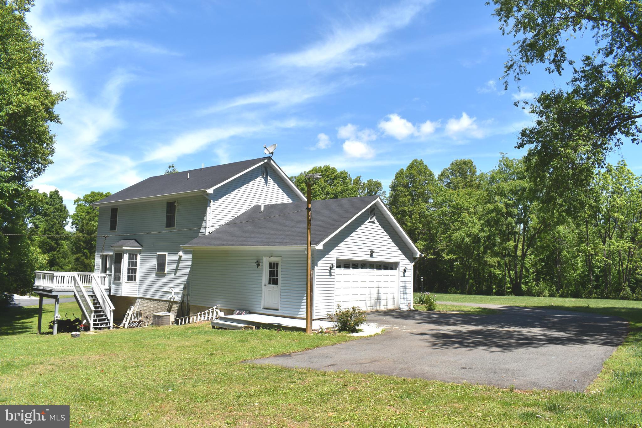 10958 Mountain Run Lake Road Culpeper, VA 22701 - Photo 25 of 31 a backyard of a house with table and chairs