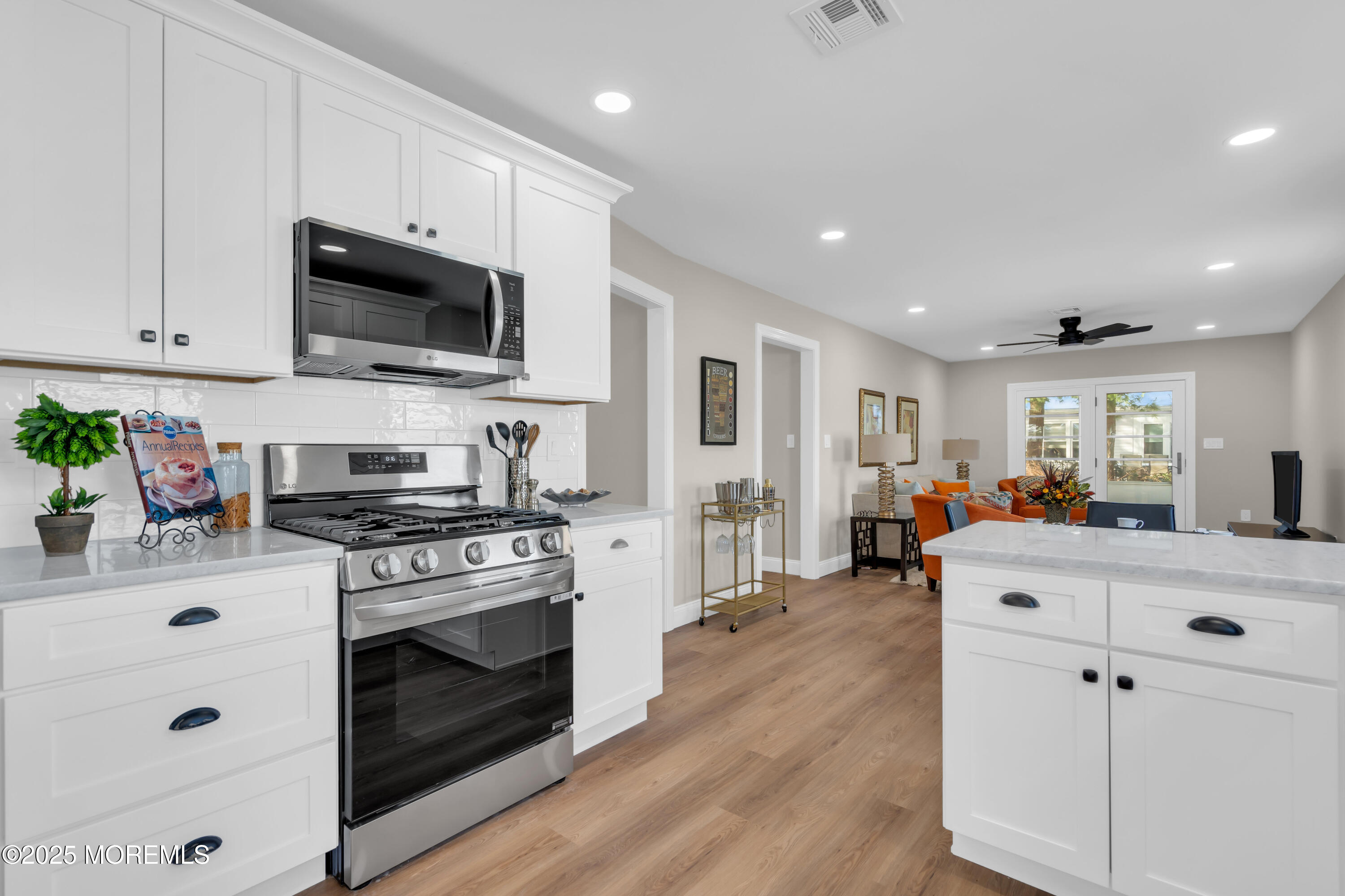 18 Meadowbrook Road Brick, NJ 08723 - Photo 47 of 47 a large white kitchen with stainless steel appliances granite countertop a stove and a sink