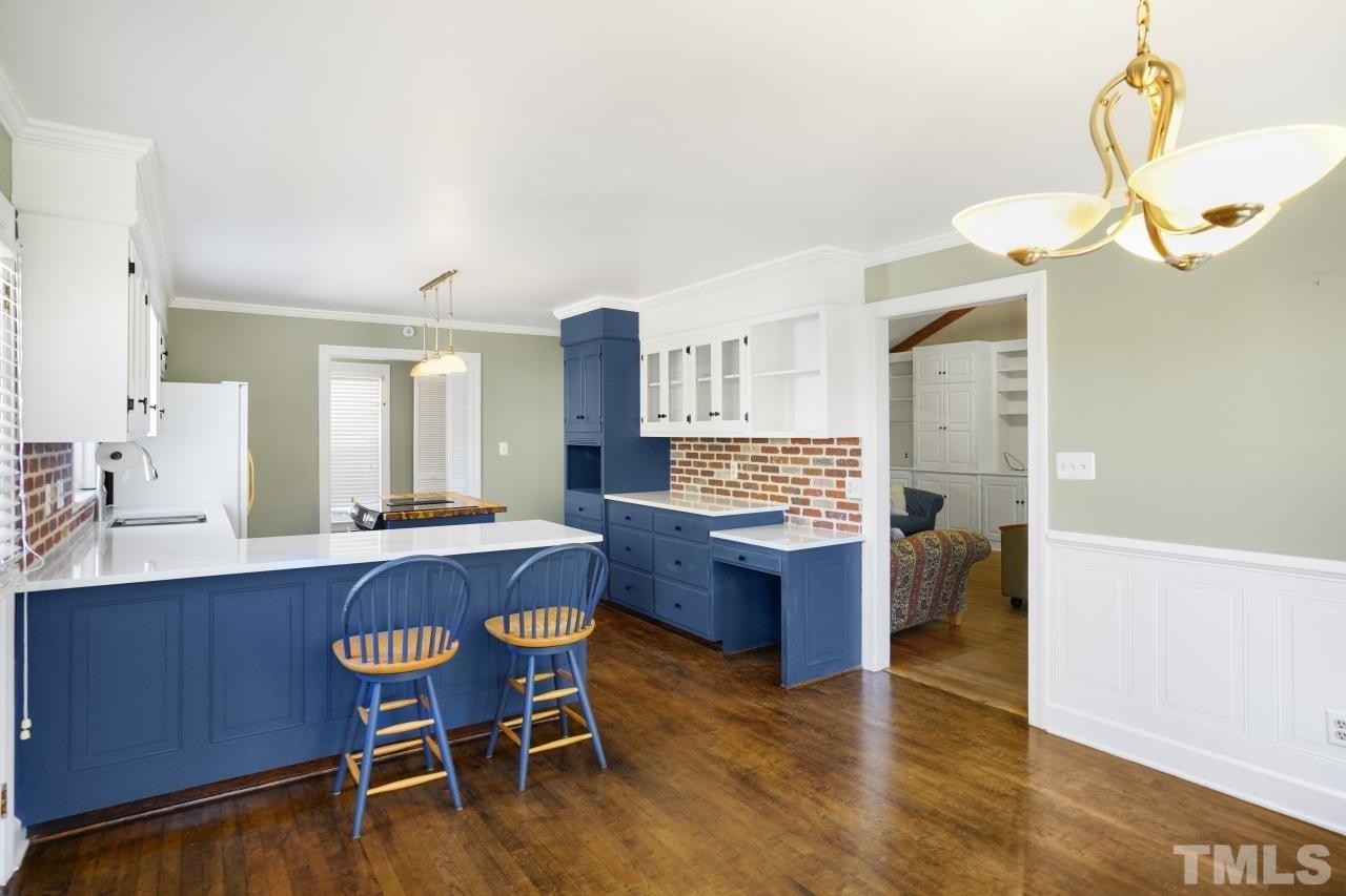 2703 Ridge Road Northwest Wilson, NC 27896 - Photo 14 of 33 a kitchen with granite countertop a table chairs stove a sink and dishwasher