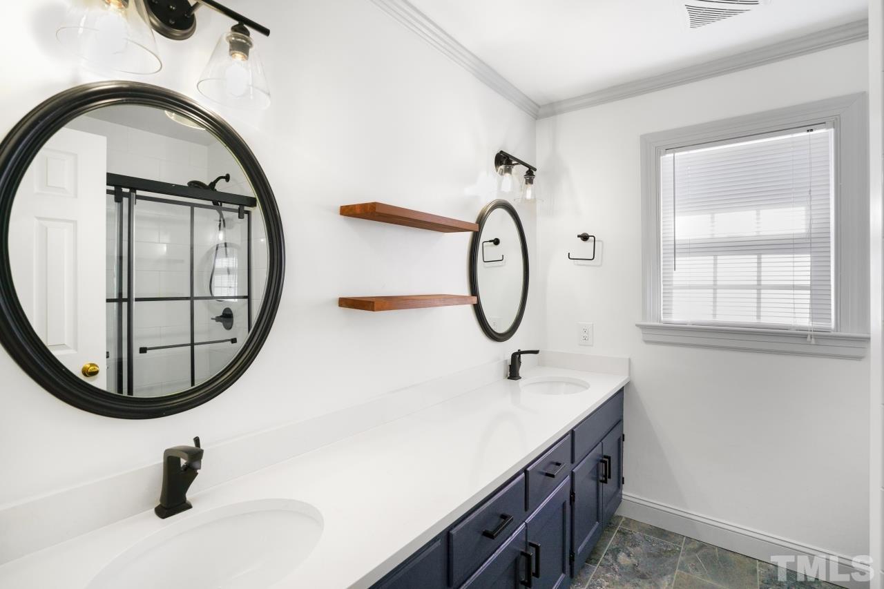 2703 Ridge Road Northwest Wilson, NC 27896 - Photo 21 of 33 a bathroom with a sink and a mirror