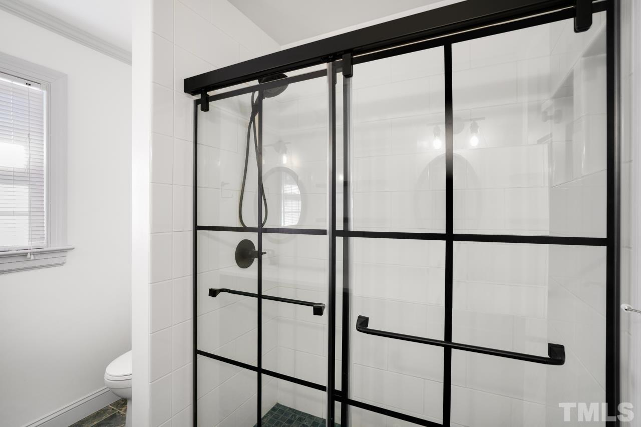 2703 Ridge Road Northwest Wilson, NC 27896 - Photo 22 of 33 a bathroom with a glass shower door