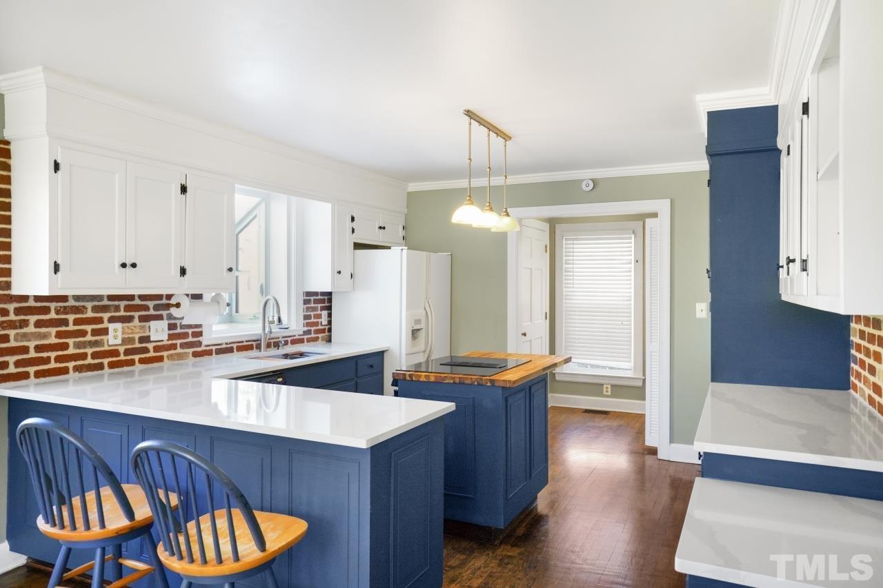 2703 Ridge Road Northwest Wilson, NC 27896 - Photo 8 of 33 a kitchen with stainless steel appliances granite countertop a sink and a refrigerator
