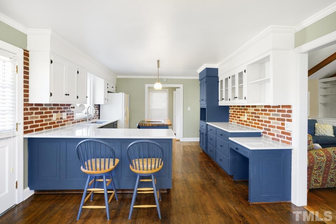 2703 Ridge Road Northwest Wilson, NC 27896 - Photo 9 of 33 a large kitchen with a dining table chairs and wooden floor