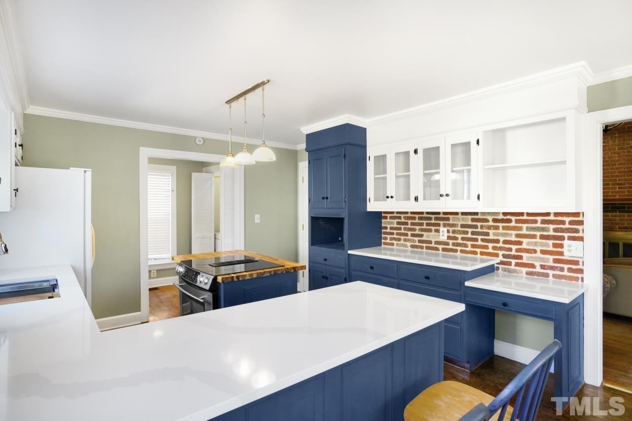 2703 Ridge Road Northwest Wilson, NC 27896 - Photo 10 of 33 a living room with stainless steel appliances kitchen island granite countertop furniture and a refrigerator