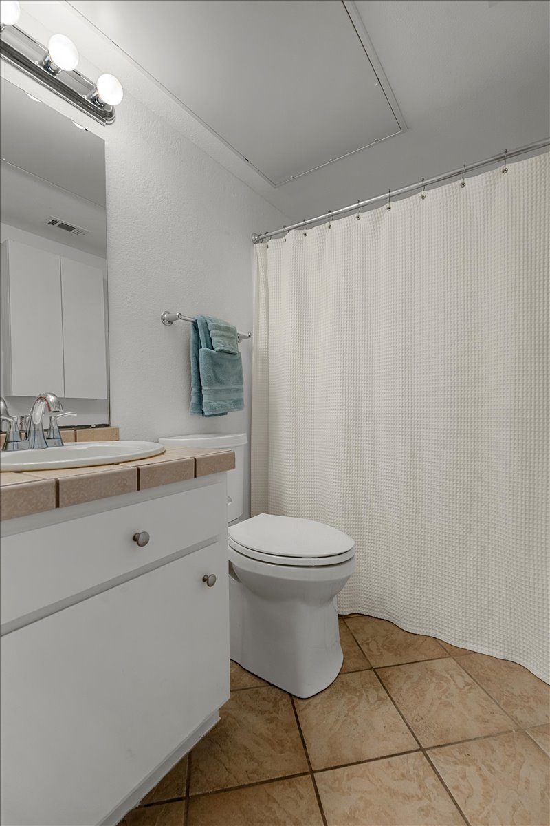 2104 Cullen Avenue, Unit 7204 Austin, TX 78757 - Photo 14 of 40 a bathroom with a toilet a sink and a mirror