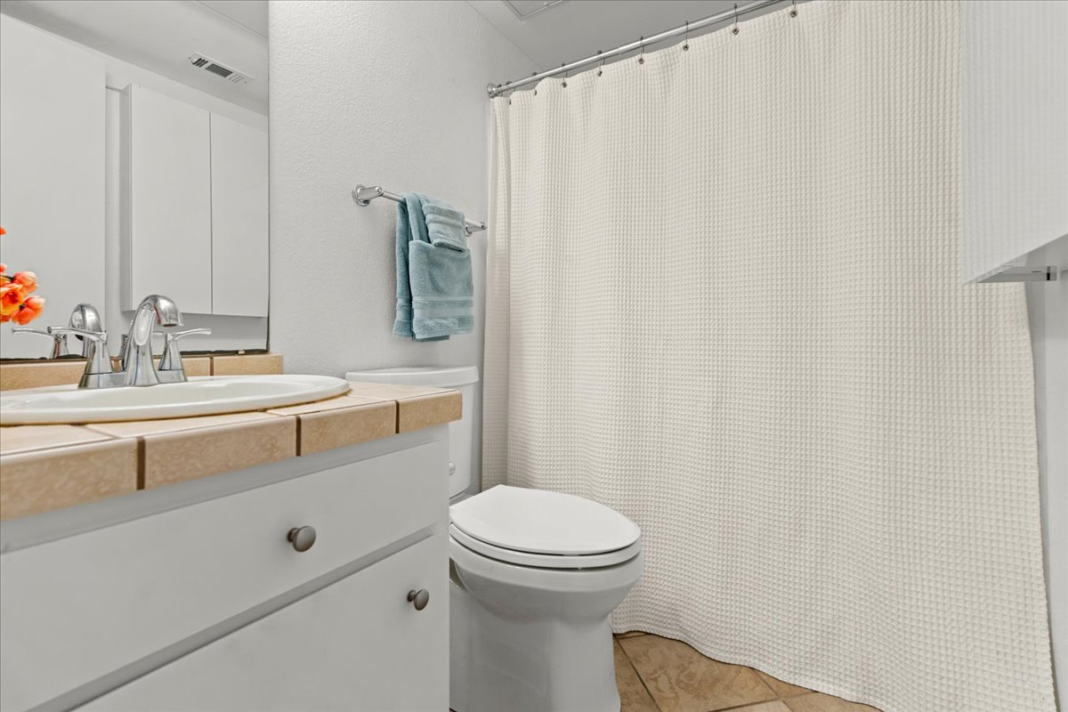 2104 Cullen Avenue, Unit 7204 Austin, TX 78757 - Photo 15 of 40 a bathroom with a sink a toilet and a mirror