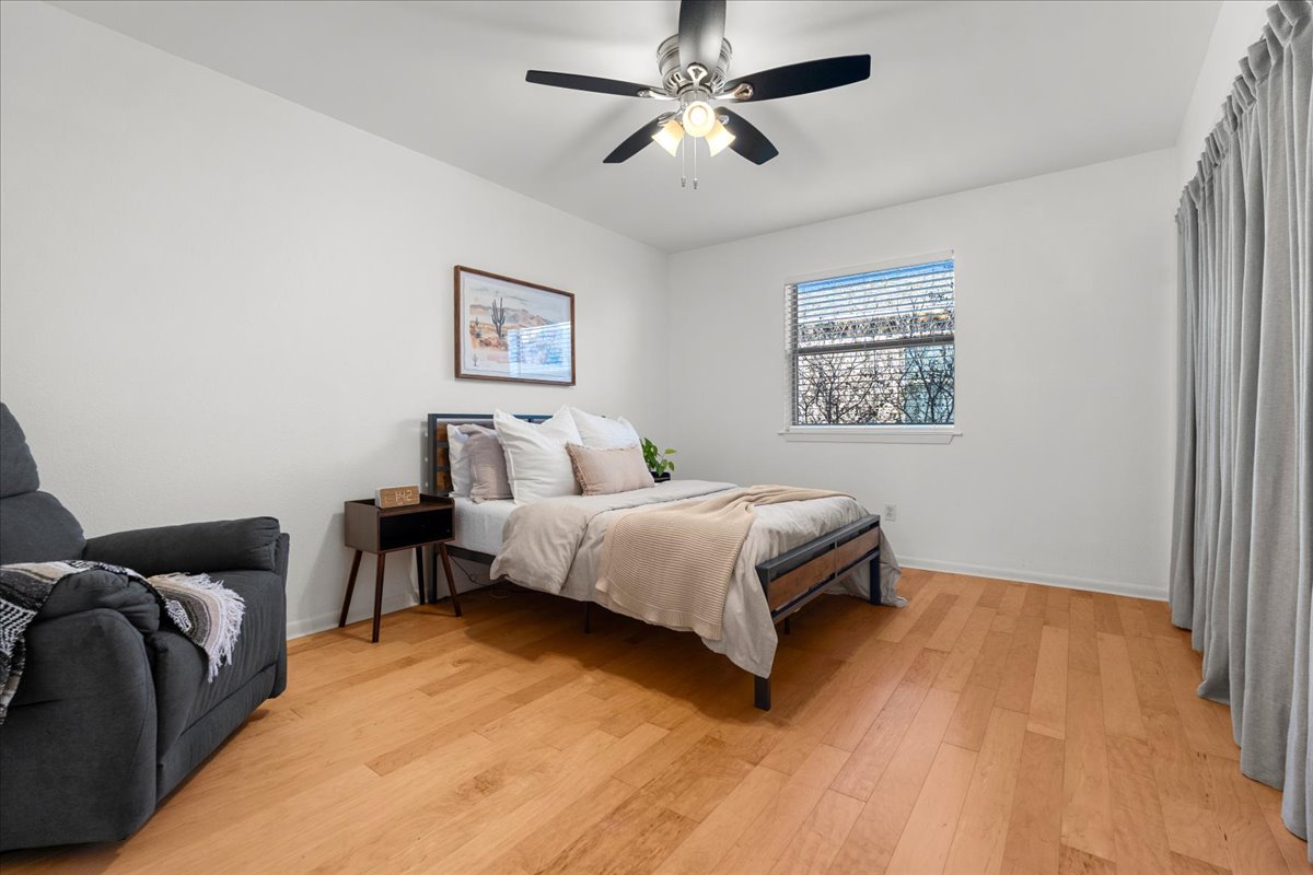 2104 Cullen Avenue, Unit 7204 Austin, TX 78757 - Photo 16 of 40 a bedroom with a bed and a painting on the wall